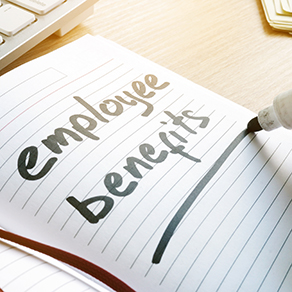 note pad with the words 'employee benefits' written on it