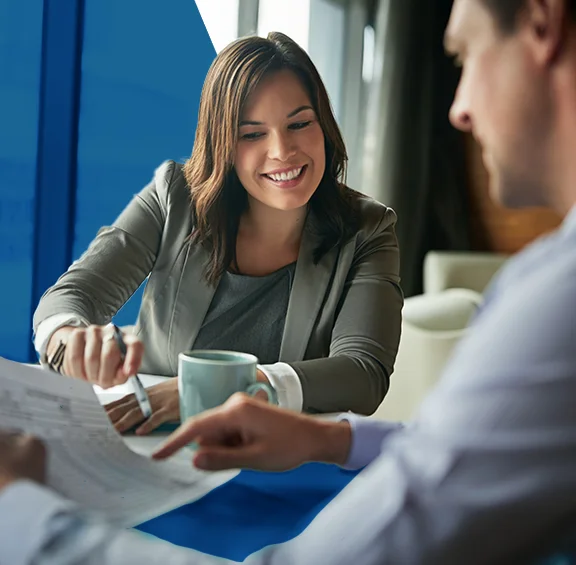 Photo of a female accountant showing a client numbers on a piece of paper