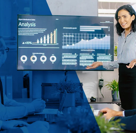 photo of woman giving financial info on large monitor