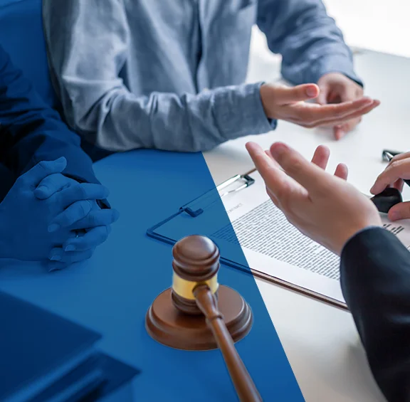 Photo of people sitting around a table with a gavel
