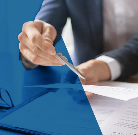 Photo of person holding pen and papers
