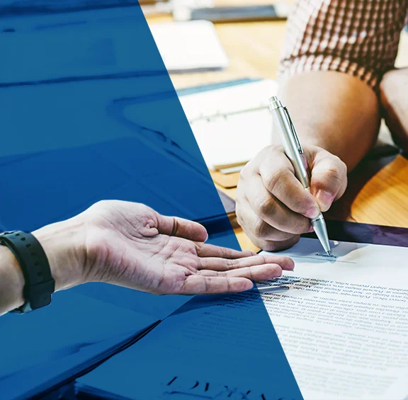 close up photo of turned over hand and hand signing paperwork