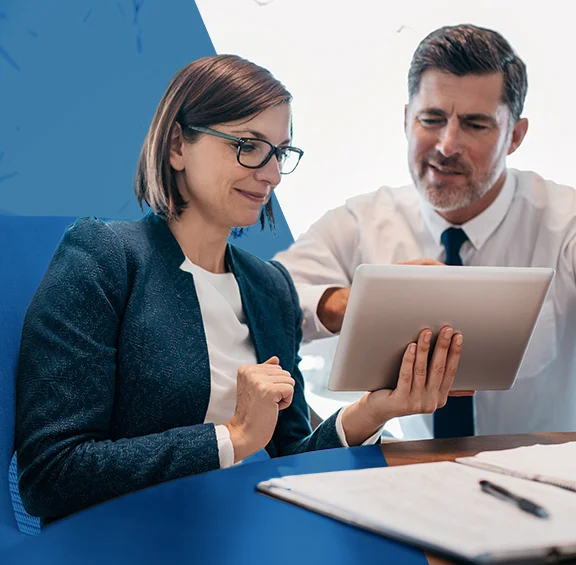 photo of business man and woman looking at tablet