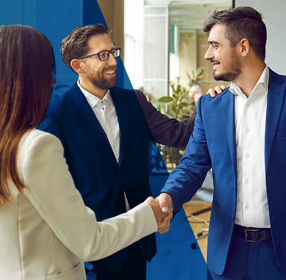 photo of two men and one woman shaking hands in a business meeting