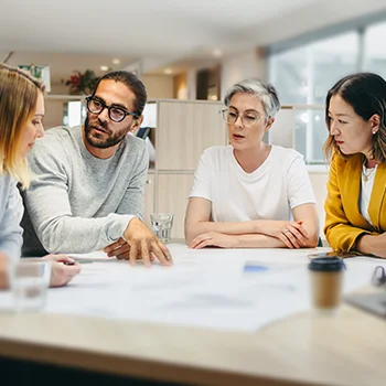 photo of business people having a discussion around a table